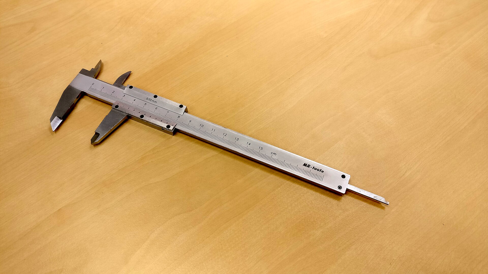 A vernier caliper resting on a flat surface